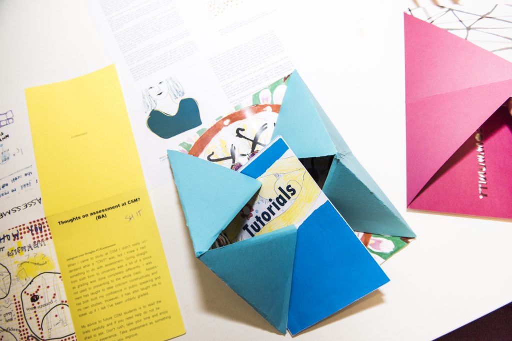 Zine on 'tutorials' with paper folded into triangular design