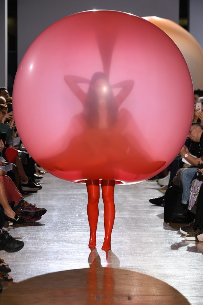 Woman inside red latex bubble dress
