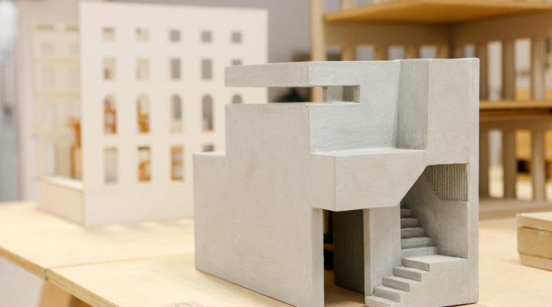 Small concrete model of a building sitting on a tabletop